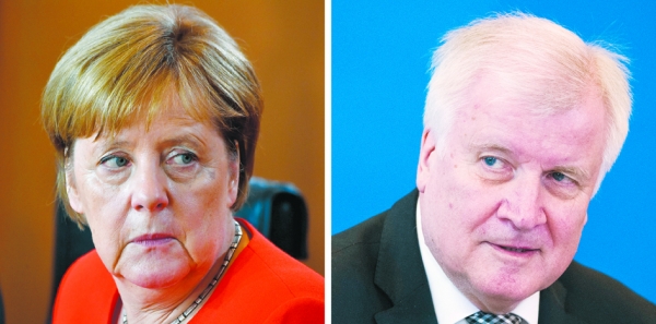 德国总理（左）和内政部长（右），他们之间关于难民的激烈矛盾有望得到解决。（AFP/Getty Images）