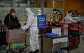图为2020年3月18日，戴着口罩的乘客抵达上海浦东国际机场（图片来源：HECTOR RETAMAL/AFP via Getty Images）