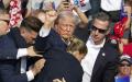 7月13日下午6点左右，美国前总统川普在宾州集会上中枪，随后在保镖拥簇下离开集会现场。（REBECCA DROKE/AFP via Getty Images)