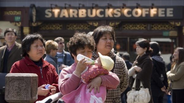 上海豫园集市妇女给孩子喂奶。（图片来源：Getty Iagems）